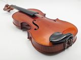 an old violin sitting on a white surface with its bow resting on it ' s back