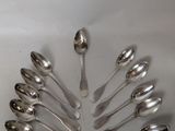 a lot of spoons arranged in a circle on the table