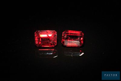 a pair of red ruby gems on a black background