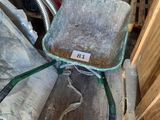 a wheelbarrow with a seat on it in a pile of wood