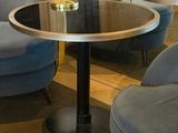 two chairs and a table with a lamp on it