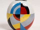 a white vase with a multicolored design on it