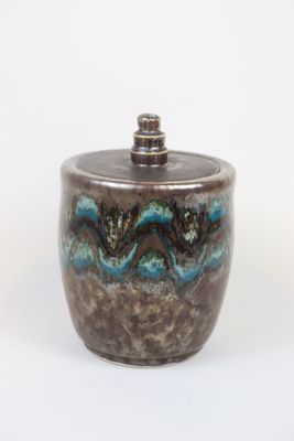 a close up of a ceramic jar with a lid