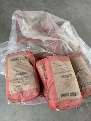 several bags of food sitting on top of a table covered in plastic