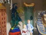 some figurines are sitting on a shelf in a room