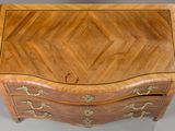 an image of a wooden chest of drawers with a chevron design