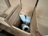 a cardboard box with a toilet in it and a roll of toilet paper in it