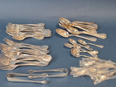 a lot of silver spoons and forks on the table