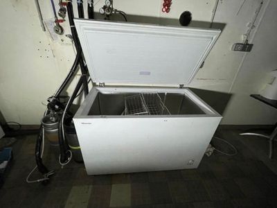 a white chest freezer sitting in a room