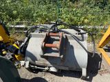 a machine that is sitting on the ground next to a tree