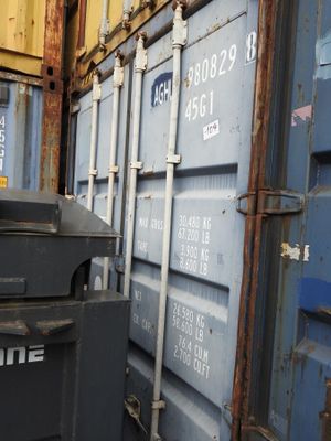 many containers stacked on top of each other next to each other