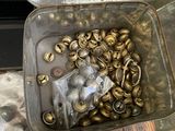 a metal container filled with lots of brass bells