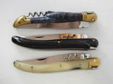 three different types of knives are lined up on a white surface