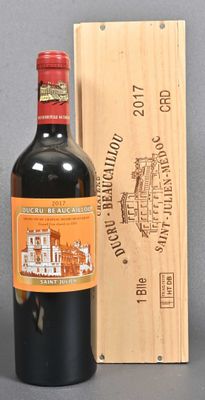 a bottle of red wine next to a wooden box