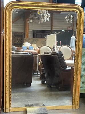 a mirror that is sitting on a table in a room