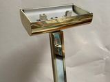 a mirror and a sink on a stand on a table