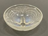 a glass bowl with a design on it on a table