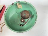 a green bowl with a bird on it next to a box of chocolates