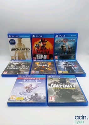 a bunch of video games sitting on top of a white table
