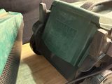 two lawn mowers that are sitting on a table