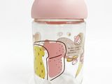 the baby bottle has a pink lid and a cartoon design on it