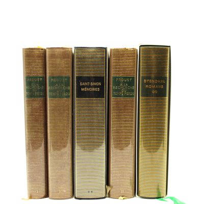 trois livres sont alignés sur une surface blanche, à côté d'une brosse à dents