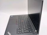 a laptop with a black keyboard sitting on a white surface