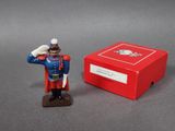 figurine of a toy soldier saluting in front of a red box