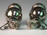 pair of silver plated salt and pepper shakers on a white surface