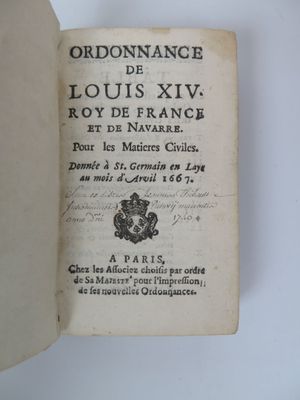 an open book with a black and white image of a coat of arms on it