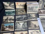 a lot of old postcards that are on a table