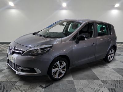 the grey car is parked in the garage on a checkered floor