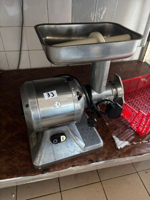 a meat grinder sitting on a counter in a kitchen
