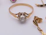 a gold ring with a diamond surrounded by other gold rings
