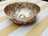 yellow and white striped tablecloth with a silver bowl on it