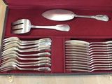 silverware in a red case on a table with a wooden surface