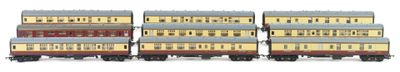 four toy trains are lined up in a row on a white surface