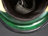 a pair of shoes in the bottom of a green and black container