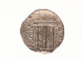 a silver coin with a design on it