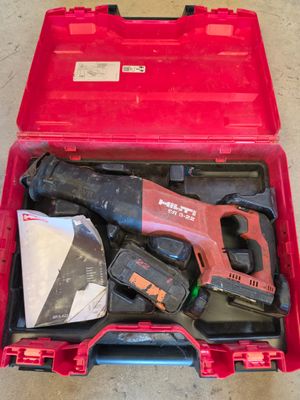 a red tool case with tools in it on the floor