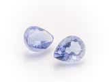 a pair of tanzanite gems on a white background