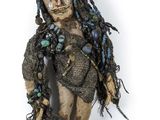 an image of a voodoo doll with dreadlocks on a white background