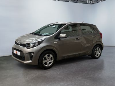 the small car is parked in the large room of the building