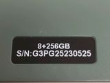 a close up of a green laptop with a sticker on it