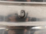 a close up of a silver plate with a hole in it