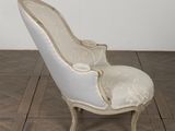 a white chair that is sitting on a wooden floor