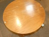 a round table with a wooden base in a room
