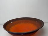 a brown bowl that is sitting on a table