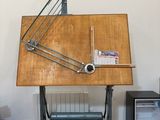 a wooden table with a drawing board on top of it