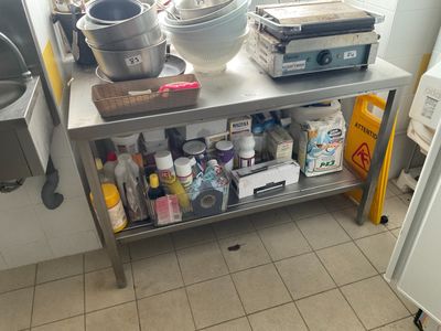 a kitchen with a table with a bunch of items on it